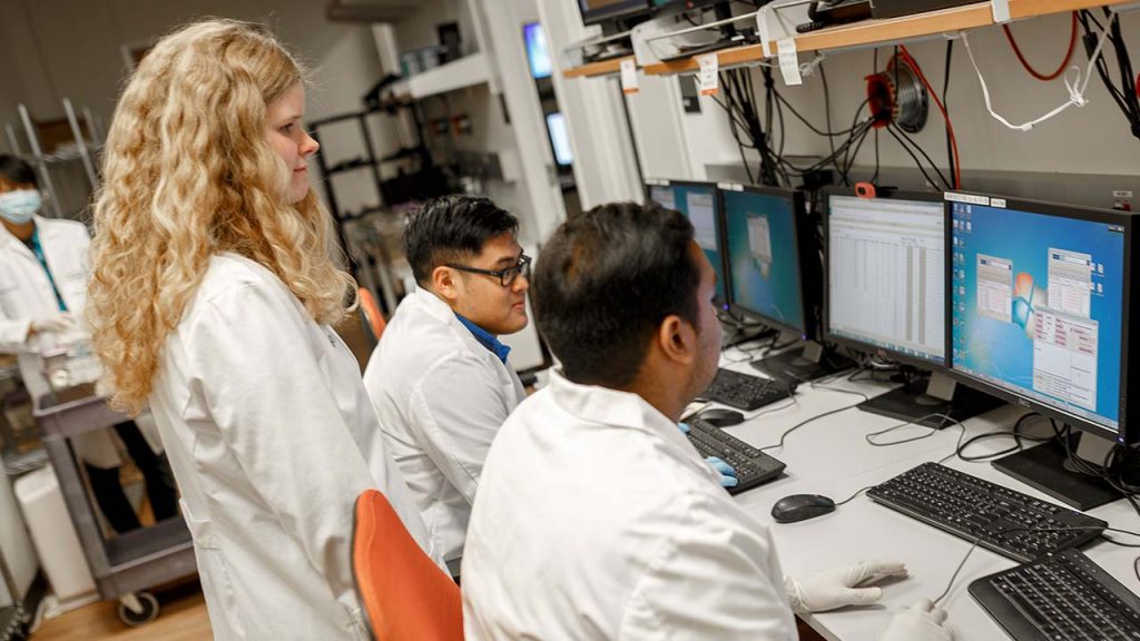 graduate student researchers working at a lab